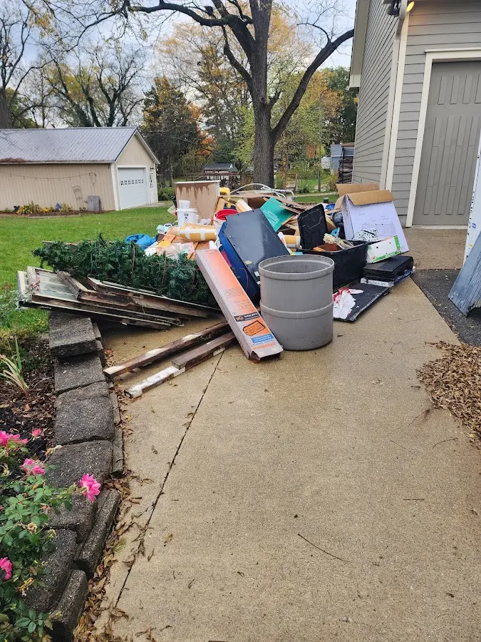 Dumpster being loaded with debris for Estate Cleanout Dumpster Rental in High Point